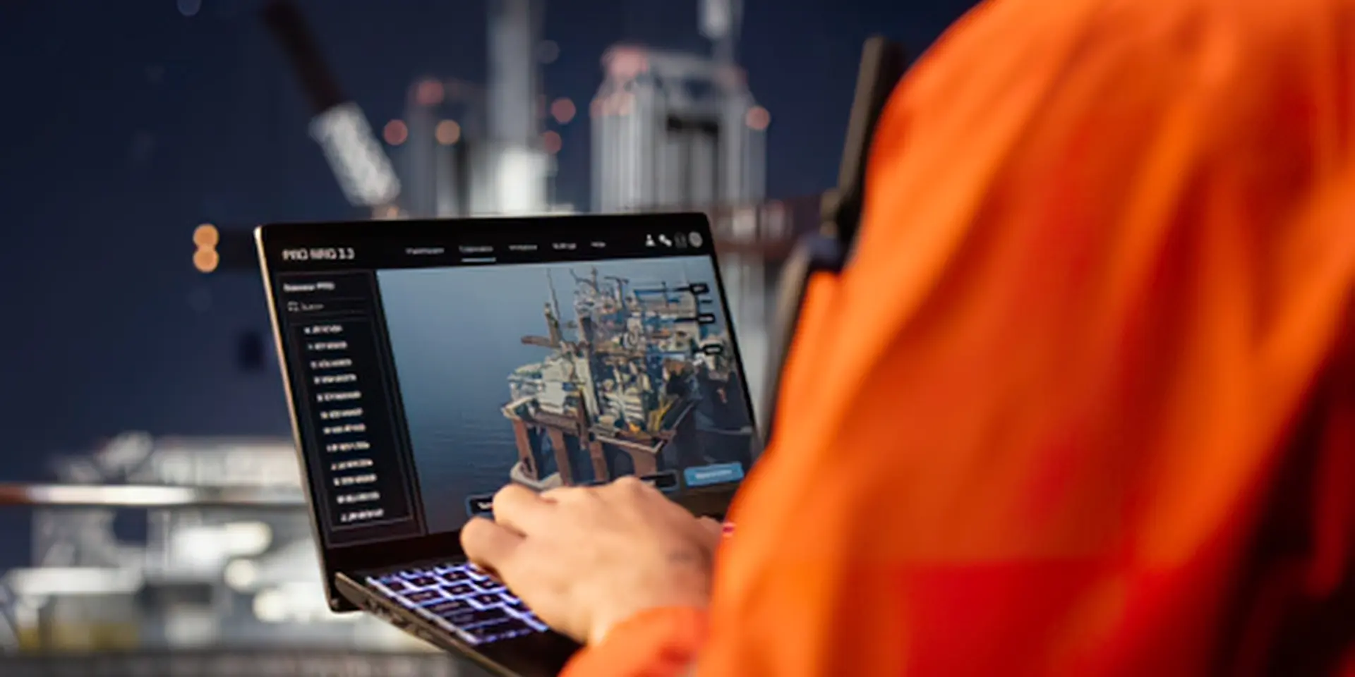 Engineer reviewing asset data on a laptop at an offshore installation at night.
